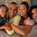 black family with mom dad son daughter on couch